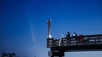 Comet C/2023 A3 (Tsuchinshan-ATLAS) is visible shortly after sunset in the western sky over the Fisherman’s Walk Pier as two men fish, in Tybee Island, Georgia, U.S. October 13, 2024.  REUTERS/Sam Wolfe     TPX IMAGES OF THE DAY