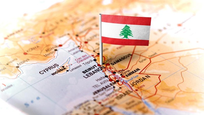 The flag of Lebanon pinned on the map. Horizontal orientation. Macro photography.