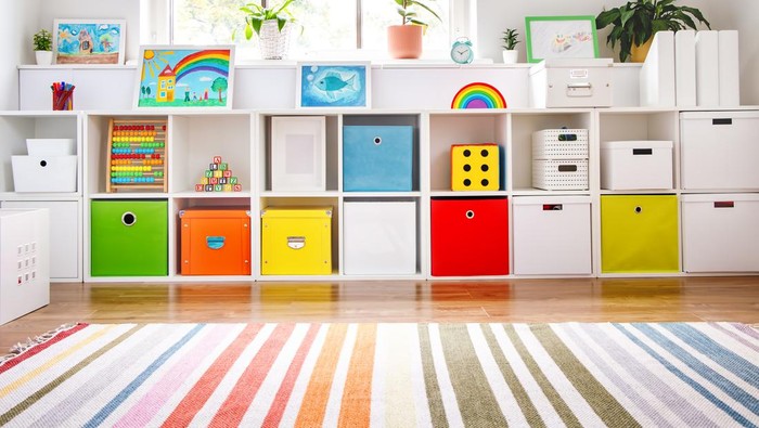 White nursery room with shelves and colourful boxes. Conceptual symbol of the preschool, kindergarten or childs cabinet.