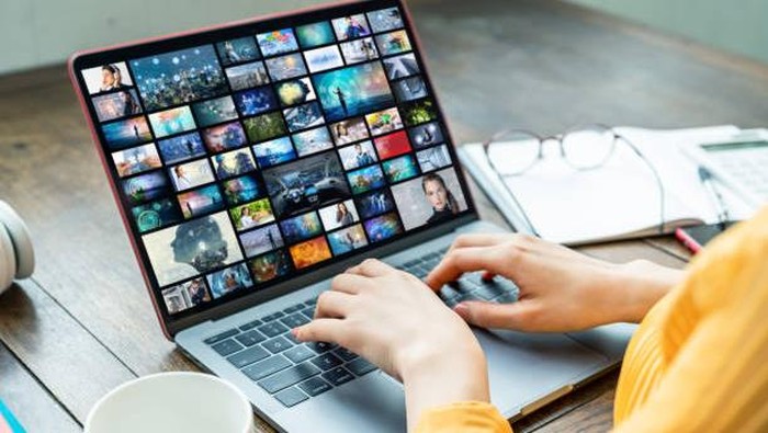 Young woman using a laptop computer. Graphic designer. UX design.