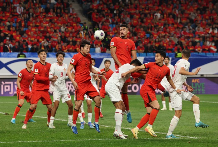 Soccer Football - World Cup - Asian Qualifiers - Third Round - Group C - China v Indonesia - Qingdao Youth Football Stadium, Qingdao, China - October 15, 2024 Chinas Jiang Guangtai and Chinas Gao Zhunyi in action REUTERS/Florence Lo