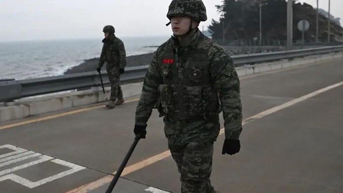 South Korean marines patrol a coastal road on Yeonpyeong island, near the northern limit line sea boundary with North Korea on January 9, 2024. (AFP)