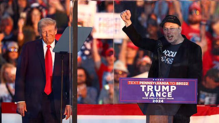 Tesla CEO and X owner Elon Musk speaks as Republican presidential nominee and former U.S. president Donald Trump looks on during a rally at the site of the July assassination attempt against Trump, in Butler, Pennsylvania, U.S., October 5, 2024. REUTERS/Carlos Barria/File Photo Purchase Licensing Rights