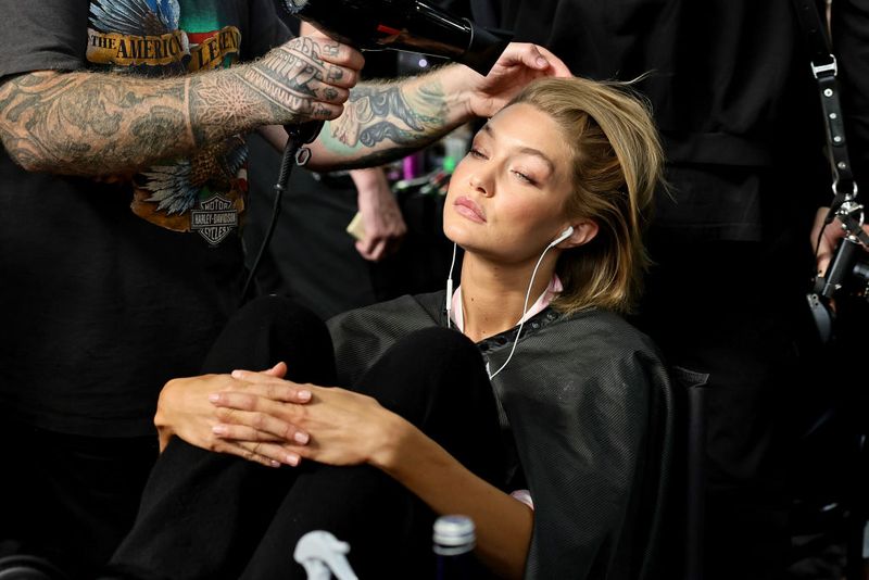 BROOKLYN, NEW YORK - OCTOBER 15: Gigi Hadid prepares backstage during the Victoria's Secret Fashion Show 2024 at Duggal Greenhouse on October 15, 2024 in Brooklyn, New York. (Photo by Theo Wargo/Getty Images)