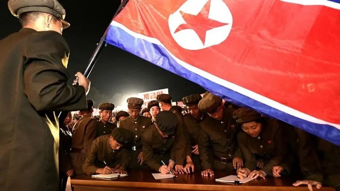 Young people, including students and youth league officials, sign petitions to join or return to the army this week, according to North Korean state media, at an undisclosed location in North Korea, in this undated photo released by North Koreas official Korean Central News Agency October 16, 2024. (Reuters)