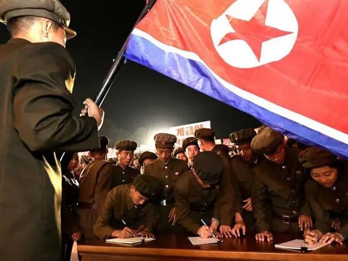 Young people, including students and youth league officials, sign petitions to join or return to the army this week, according to North Korean state media, at an undisclosed location in North Korea, in this undated photo released by North Koreas official Korean Central News Agency October 16, 2024. (Reuters)