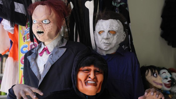 A mask of former Bolivian President Evo Morales sits for sale between other Halloween masks at a costume store in La Paz, Bolivia, Tuesday, Oct. 15, 2024. (AP Photo/Juan Karita)