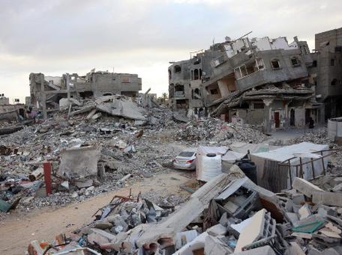 A car drives past destroyed buildings in Khan Yunis in the southern Gaza Strip on October 17, 2024, amid the ongoing war between Israel and the Palestinian militant group Hamas in the besieged Palestinian territory. (Photo by BASHAR TALEB / AFP)