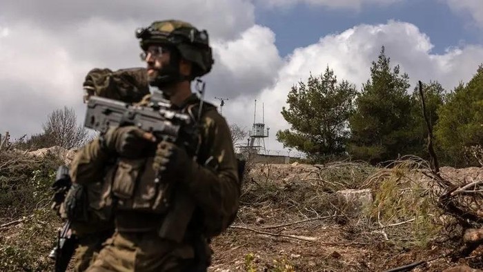 This picture taken on October 13, 2024 during a controlled embed organised by the Israeli military, shows Israeli troops patrolling near a United Nations Interim Force In Lebanon (UNIFIL) base in the southern Lebanons Naqoura region near the border. (AFP)