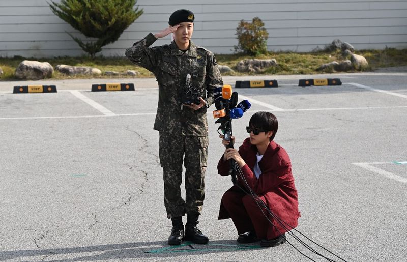 BTS member J-hope reacts after being discharged from his mandatory military service outside a military base in Wonju on October 17, 2024. K-pop megastar J-hope from BTS ended eighteen months of South Korean military service on October 17, and hailed the 