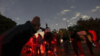 People attend a stargazing and comet-watching gathering at Joya-La Barreta ecological park as comet Tsuchinshan–ATLAS flies overhead in Queretaro, Mexico, Saturday, Oct. 19, 2024. (AP Photo/Ginnette Riquelme)