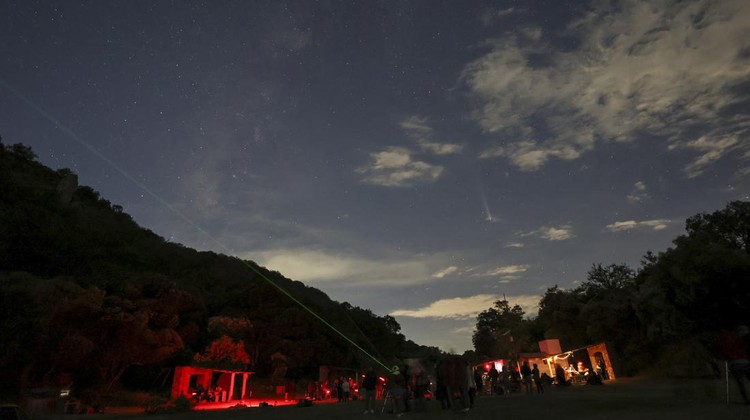 People attend a stargazing and comet-watching gathering at Joya-La Barreta ecological park as comet Tsuchinshan–ATLAS flies overhead in Queretaro, Mexico, Saturday, Oct. 19, 2024. (AP Photo/Ginnette Riquelme)