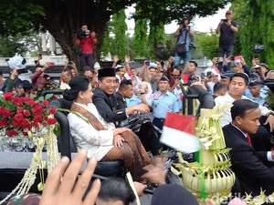 Naik Mobil Pindad, Jokowi dan Iriana Bagi-bagi Kaus ke Warga Solo