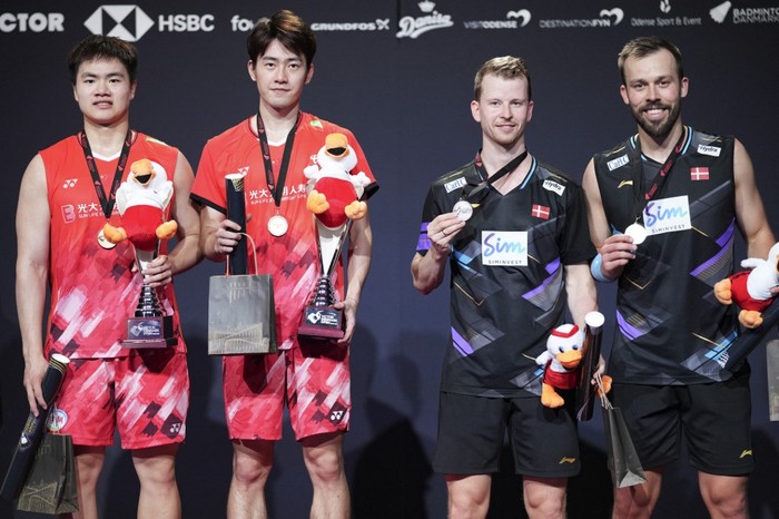 Chinas Liang Weikeng and Wang Chang pose with Denmarks Kim Astrup and Anders Skaarup Rasmussen after the mens doubles final badminton match at the Victor Denmark Open in Odense part of the of the Badminton World Tour on October 20, 2024. (Photo by Claus Fisker / Ritzau Scanpix / AFP) / Denmark OUT