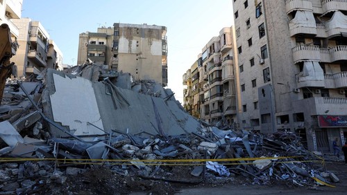 A man rides a scooter past a damaged site, in the aftermath of Israeli airstrikes on Sunday that hit several branches of Al-Qard al-Hassan, a financial institution linked to Lebanons Hezbollah, in Chiyah, Lebanon October 21, 2024. REUTERS/Mohamed Azakir