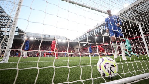 LIVERPOOL, ENGLAND - OCTOBER 20: Tosin Adarabioyo of Chelsea reacts as Curtis Jones of Liverpool celebrates scoring his teams second goal  during the Premier League match between Liverpool FC and Chelsea FC at Anfield on October 20, 2024 in Liverpool, England. (Photo by Carl Recine/Getty Images)