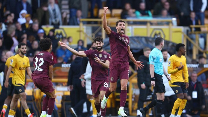 Soccer Football - Premier League - Wolverhampton Wanderers v Manchester City - Molineux Stadium, Wolverhampton, Britain - October 20, 2024 Manchester Citys Ruben Dias and Rico Lewis celebrate after their second goal, scored by John Stones, was allowed after a referral to VAR REUTERS/Molly Darlington EDITORIAL USE ONLY. NO USE WITH UNAUTHORIZED AUDIO, VIDEO, DATA, FIXTURE LISTS, CLUB/LEAGUE LOGOS OR LIVE SERVICES. ONLINE IN-MATCH USE LIMITED TO 120 IMAGES, NO VIDEO EMULATION. NO USE IN BETTING, GAMES OR SINGLE CLUB/LEAGUE/PLAYER PUBLICATIONS. PLEASE CONTACT YOUR ACCOUNT REPRESENTATIVE FOR FURTHER DETAILS..