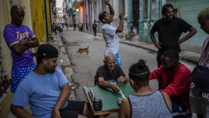 People play dominoes on the street during a power outage in Havana, Cuba, Monday, Oct. 21, 2024. (AP Photo/Ramon Espinosa)