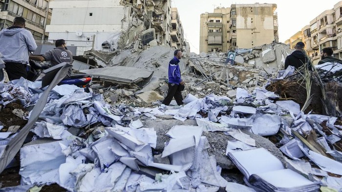 Documents of Hezbollah-run al-Qard al-Hassan are scattered at the site of an Israeli airstrike on Sunday night in Beiruts southern suburb, Lebanon, Monday, Oct. 21, 2024. (AP Photo/Hassan Ammar)