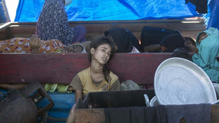 A young Rohingya girl sits on the deck of a refugee boat anchored in the waters near the coast of Labuhan Haji, Aceh province, Indonesia, Tuesday, Oct. 22, 2024. (AP Photo/Binsar Bakkara)