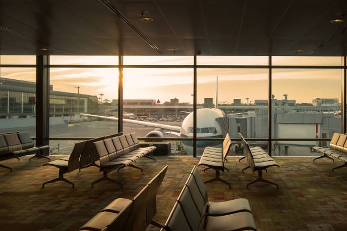 Airplane view from airport lounge in airport terminal.