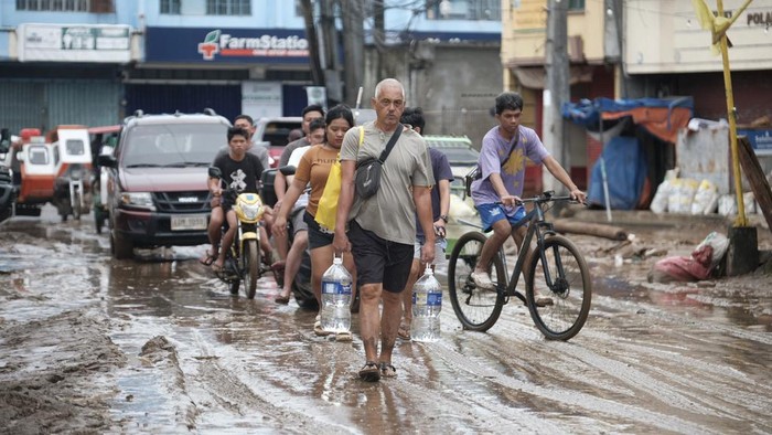 Debris from a damaged road and electric posts caused by Tropical Trami, locally named Kristine, in Polangui, Albay province, Philippines on Oct. 23, 2024. (AP Photo/John Michael Magdasoc)