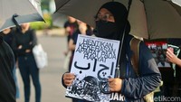 Mereka membawa sejumlah poster dalam aksi tersebut.