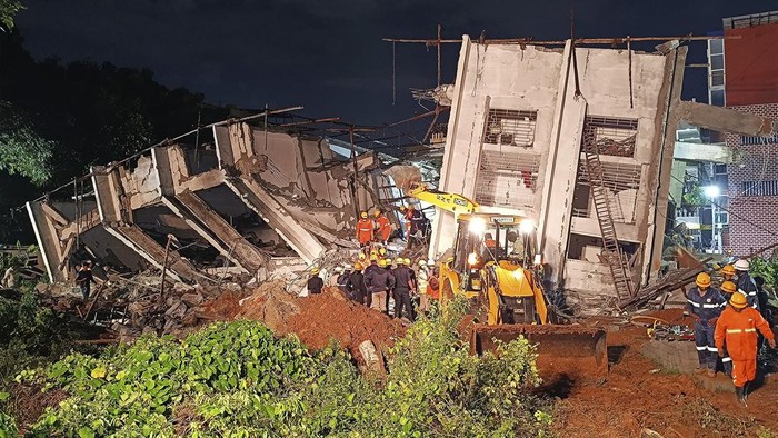 Rescue workers remove the debris to look for the trapped survivors of an under-construction building that collapsed on Tuesday, following heavy rains in Bengaluru, India, Wednesday, Oct. 23, 2024. (AP Photo/Aijaz Rahi)