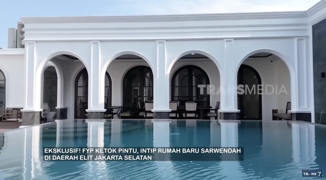 Halaman belakang difungsikan untuk kolam renang yang cukup luas. Pilar-pilar rumah yang melengkuh semakin menambah kesan mewah. (Foto: YouTube/Trans7 Official)