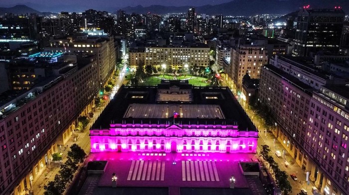 A drone view shows La Moneda government palace lit up in pink light as part of the breast cancer awareness month, in Santiago, Chile October 24, 2024. REUTERS/Ivan Alvarado