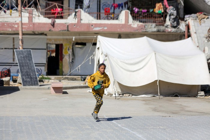 A displaced Palestinian girl runs in a school-turned shelter, amid the ongoing Israel-Hamas conflict, in Gaza City, October 24, 2024. REUTERS/Dawoud Abu Alkas