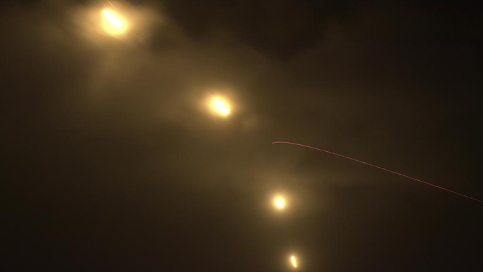 Tracer rounds fired from machine guns to the flares in the air during a military drill on the outlying Penghu Island, Taiwan, Thursday, Oct. 24, 2024. (AP Photo/Chiang Ying-ying)