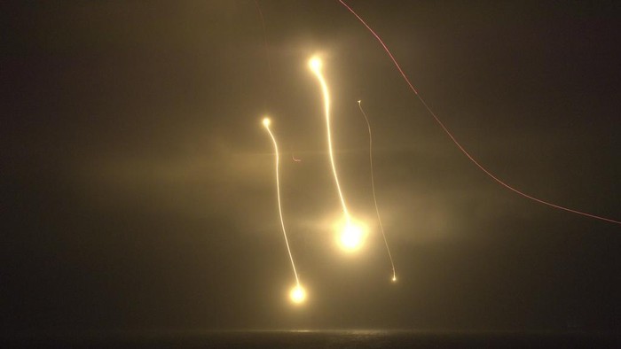 Tracer rounds fired from machine guns to the flares in the air during a military drill on the outlying Penghu Island, Taiwan, Thursday, Oct. 24, 2024. (AP Photo/Chiang Ying-ying)