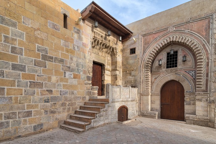 Gate of Darb Al Labana, a Bahari Mameluke era gate with small iron bars window and decorated with wooden and stone decorative elements with geometric designs, and gate of Tekkeyet Al-Bustami