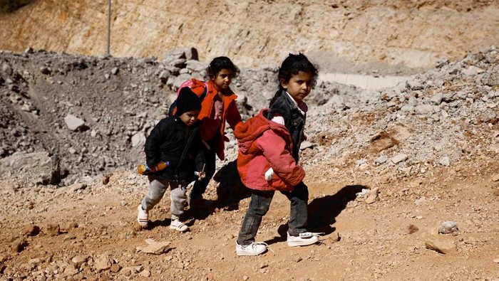 Children cross from Lebanon into Syria on foot at the Masnaa border crossing, after an Israeli strike, as they flee the ongoing hostilities between Hezbollah and Israeli forces, in Al Masnaa, Lebanon October 27, 2024. REUTERS/Yara Nardi