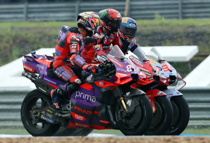 MotoGP - Thailand Grand Prix - Chang International Circuit, Buriram, Thailand - October 27, 2024 Ducati Lenovo Team's Francesco Bagnaia after winning the MotoGP along with second placed Prima Pramac Racing's Jorge Martin and Gresini Racing MotoGP's Marc Marquez REUTERS/Athit Perawongmetha
