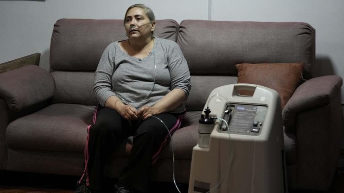 Cancer patient Linda Vidal, who relies on an electricity-powered oxygen concentrator to breathe properly, sits for an interview to talk about her physical and mental health amid the electricity cuts of up to 14 hours a day to deal with a severe drought, in Quito, Ecuador, Thursday, Oct. 24, 2024. (AP Photo/Dolores Ochoa)