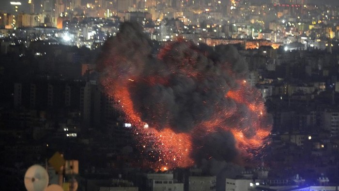 Flame and smoke rises from buildings hit by Israeli airstrikes on Dahiyeh, in the southern suburb of Beirut, Lebanon, early Sunday, Oct. 27, 2024. (AP Photo/Hussein Malla)