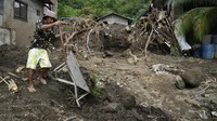 Sebagian warga mulai membersihkan material longsor yang menimbun rumahnya. AP Photo/Aaron Favila.