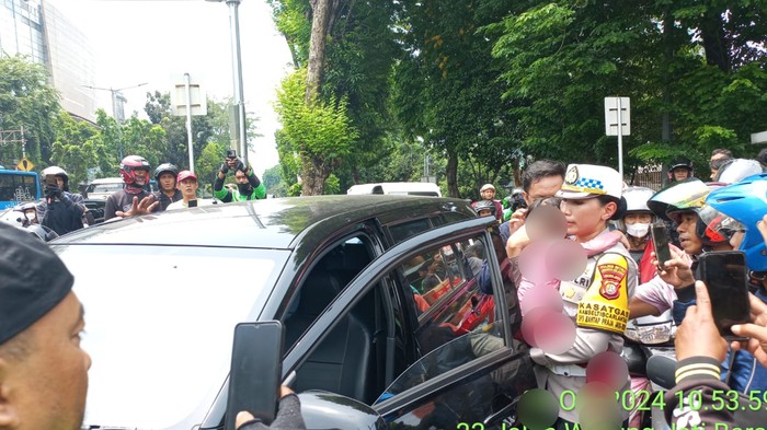 Kasat Lantas Jaksel Kompol Yunita Rungkat membawa bocah yang disandera usai pelaku dilumpuhkan polisi di Pospol Pejaten, Jaksel, Senin (28/10/2024).