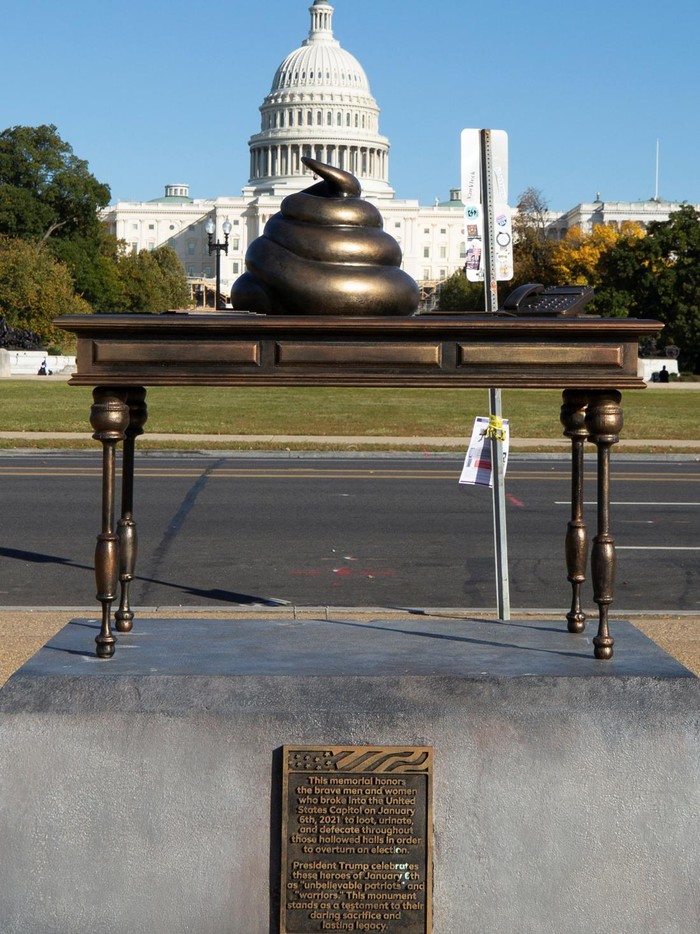 A new temporary statue of a brass-colored desk with a large poop-shaped emoji on top of it, referencing those who attacked the U.S. Capitol on January 6, 2021, is seen near the Capitol in Washington, U.S., October 25, 2024. REUTERS/Kaylee Greenlee Beal