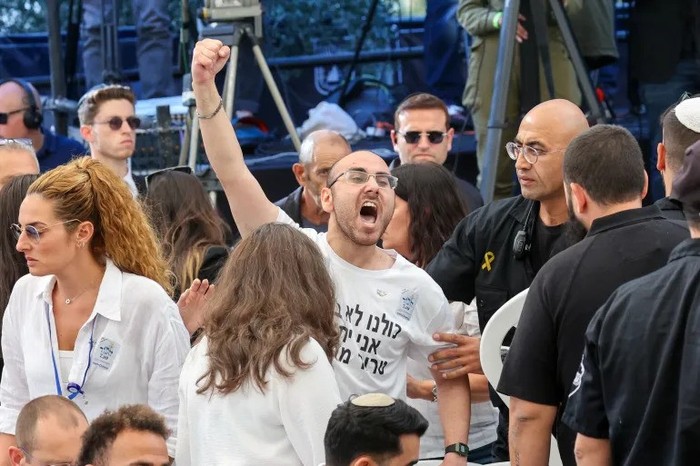 A man shouts as Israeli Prime Minister Netanyahu speaks during a memorial ceremony at the Mount Herzl military cemetery in Jerusalem on October 27, 2024. [Gil Cohen-Magen/Pool via Reuters]