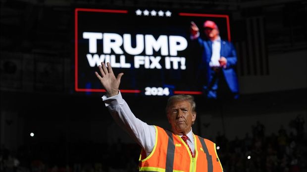 Republican presidential nominee former President Donald Trump talks to reporters as he sits in a garbage truck Wednesday, Oct. 30, 2024, in Green Bay, Wis. (AP Photo/Julia Demaree Nikhinson)