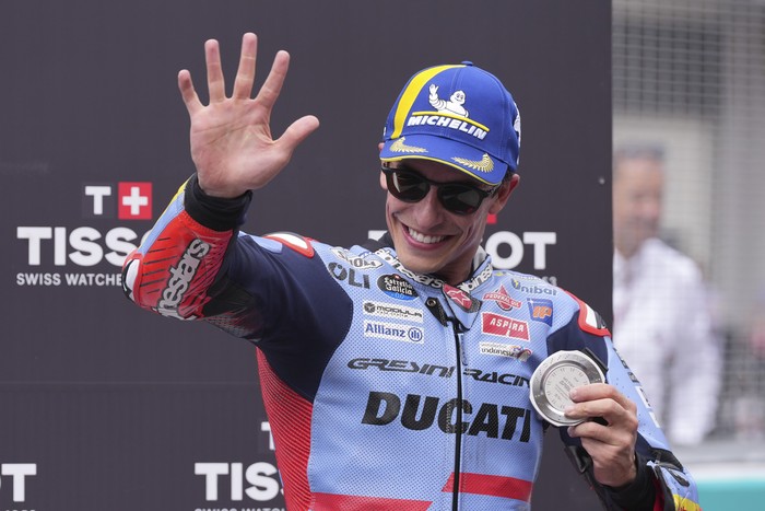 Spanish rider Marc Marquez of Gresini Racing MotoGP celebrates with his silver medal after the sprint race at Sepang International Circuit ahead of MotoGP race in Sepang, outskirts of Kuala Lumpur, Saturday, Nov. 2, 2024. (AP Photo/Vincent Thian)