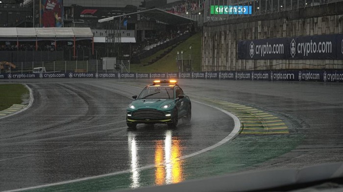 SAO PAULO, BRAZIL - NOVEMBER 2: Maintenance teams and race directors circulate around the Interlagos track to assess race conditions for qualifying, during a storm that hit the city of Sao Paulo on Saturday afternoon 2. After more than 1 hour of rain, qualifying was cancelled. (Photo by Stringer/Anadolu via Getty Images)