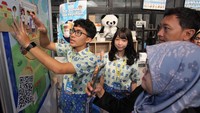 Salah satu murid peserta pameran karya menjelaskan projeknya ke pengunjung. Foto: (Dokumentasi Yayasan Guru Belajar)
