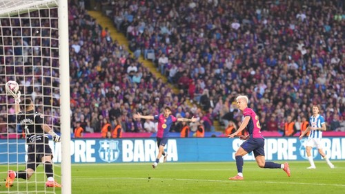 BARCELONA, SPAIN - NOVEMBER 03: Dani Olmo of FC Barcelona scores his teams first goal as Joan Garcia of RCD Espanyol fails to make a save during the La Liga EA Sports match between FC Barcelona and RCD Espanyol at Estadi Olimpic Lluis Companys on November 03, 2024 in Barcelona, Spain. (Photo by Alex Caparros/Getty Images)