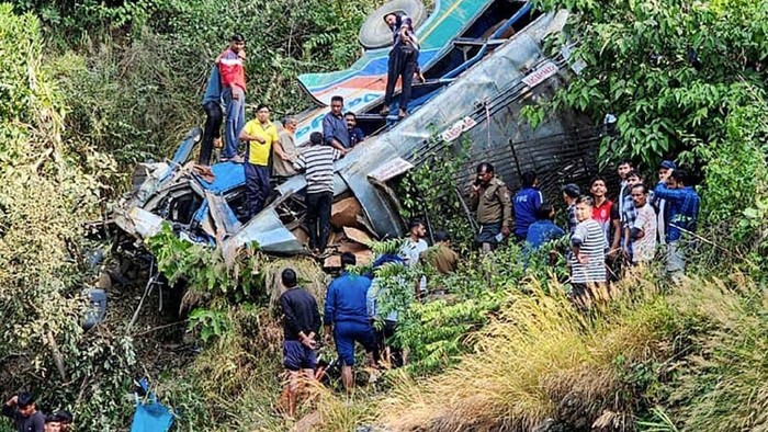 People at the site of a bus accident, after it fell into a gorge at Almora district in India’s Uttarakhand state. PHOTO: AFP