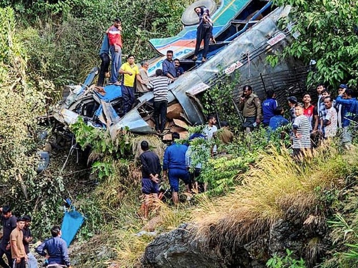People at the site of a bus accident, after it fell into a gorge at Almora district in India’s Uttarakhand state. PHOTO: AFP