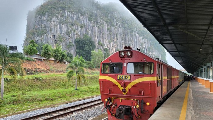 Kelantan, Malaysia - 21 FEBRUARY 2022 : Train stopped in Gua musang station during foggy morning before continuing journey to the next station.